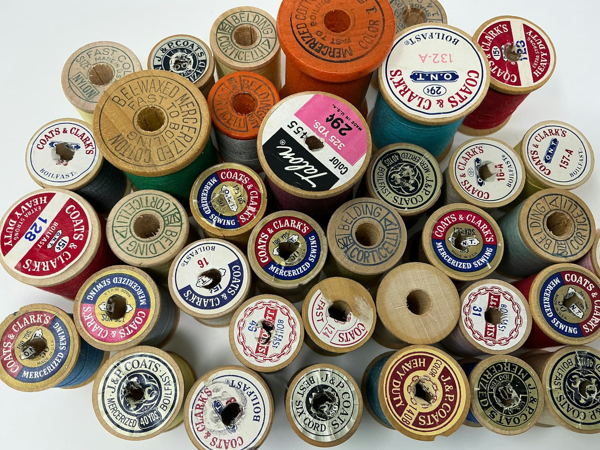 Vintage thread spools in assorted colours, seen from above